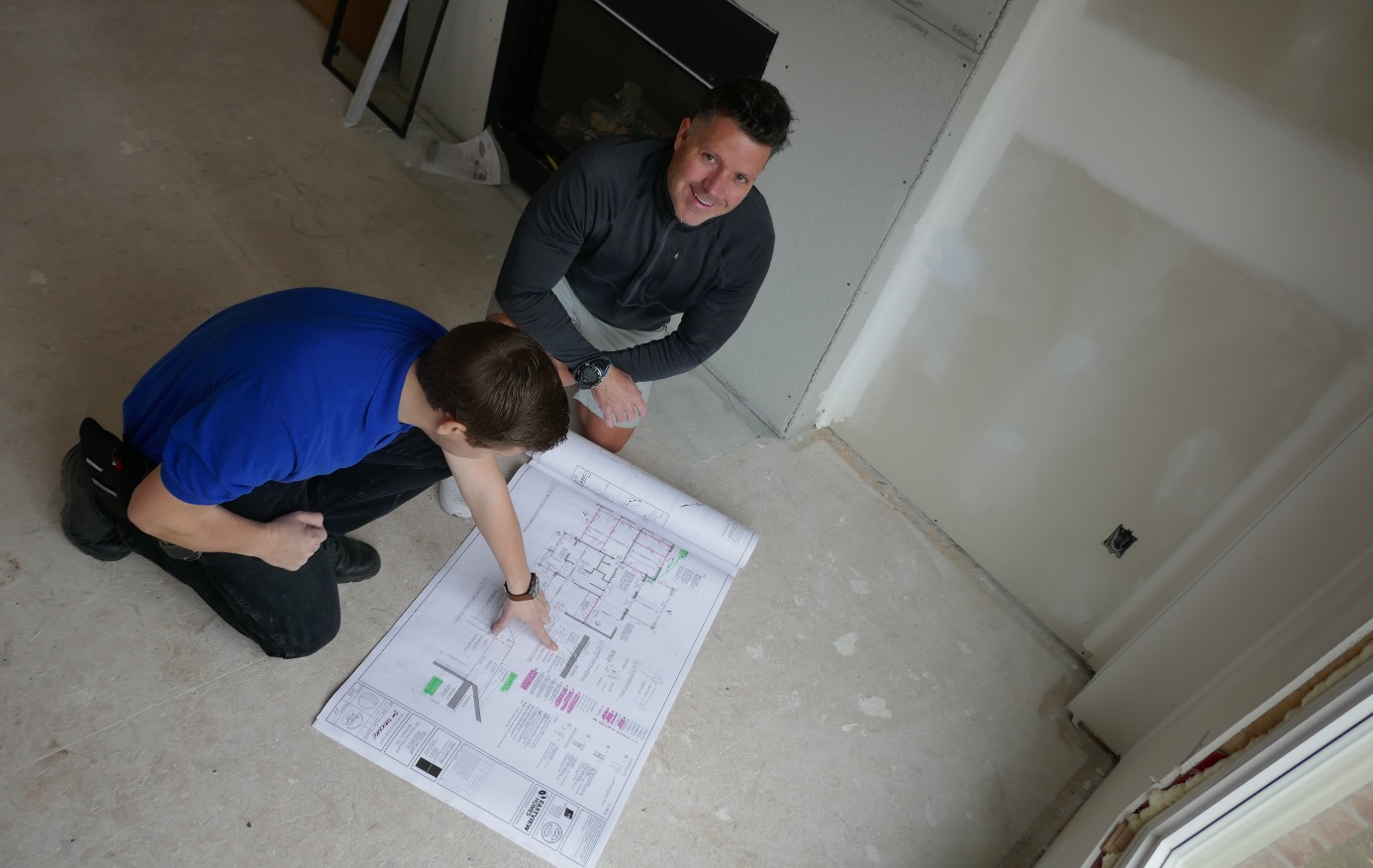 inspecting the plans for a home in Oakville