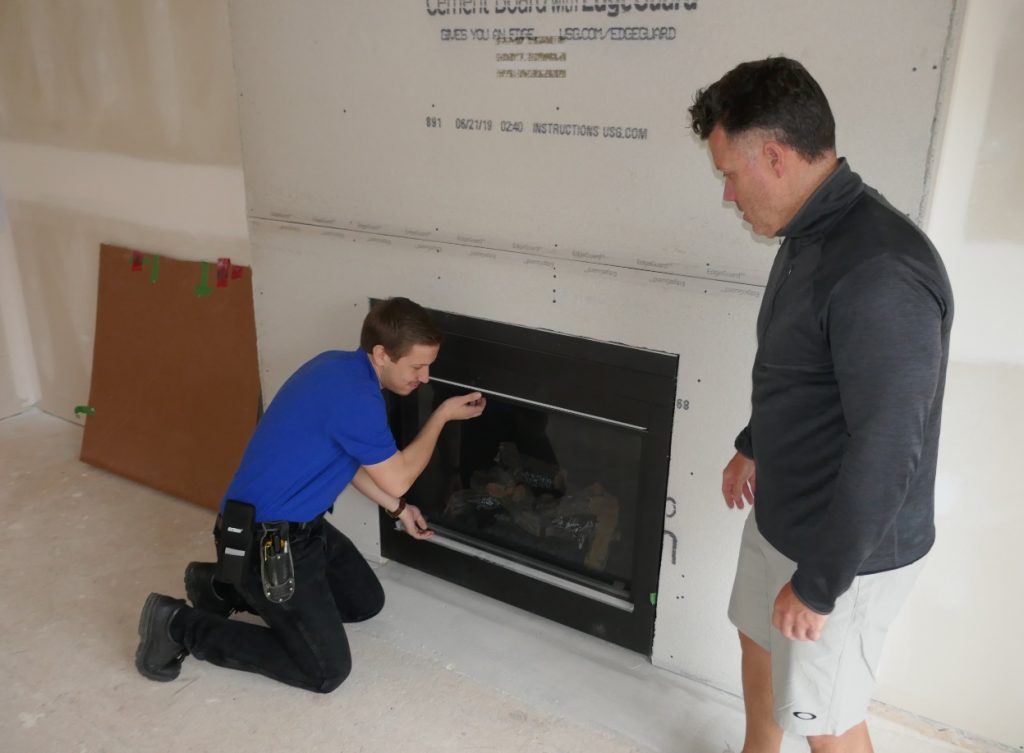 Boris opens fireplace to inspect the interior