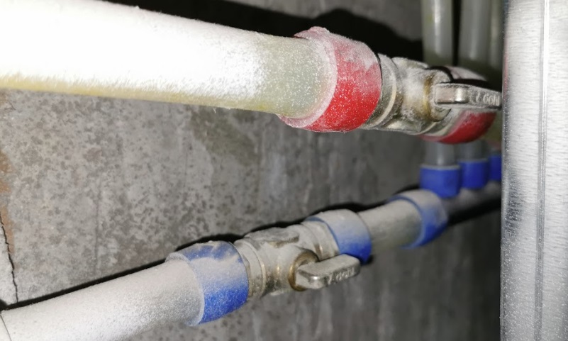 The main hot and cold water pipes with 'shut-off valves' in a modern condo unit.